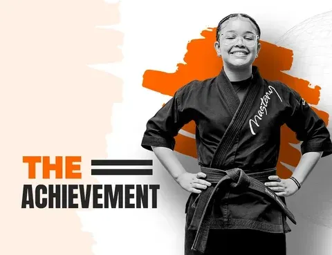 Child celebrating The Achievement in martial arts