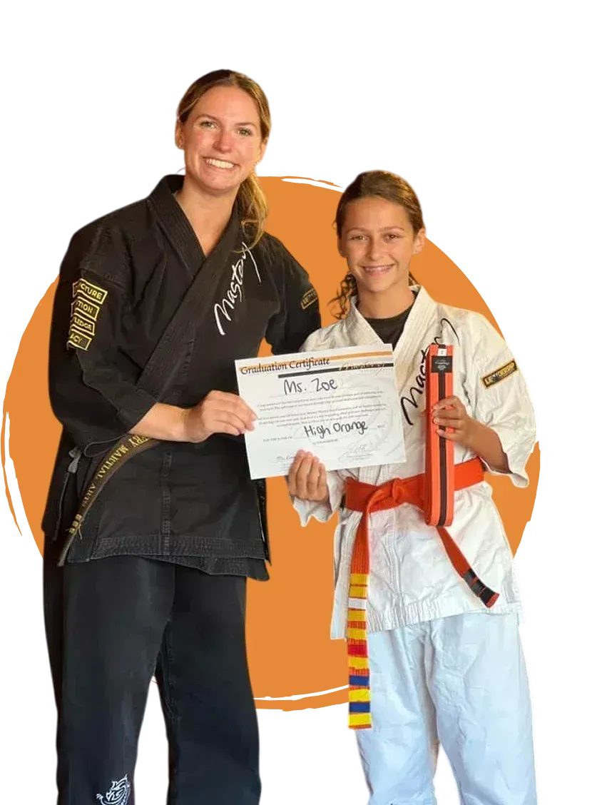 Kids karate classes Troy MI - student receiving graduation certificate at Mastery Martial Arts