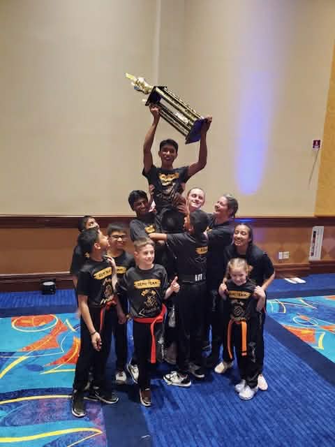 Mastery Troy Demo Team celebrating their 1st place trophy at Night of Champions
