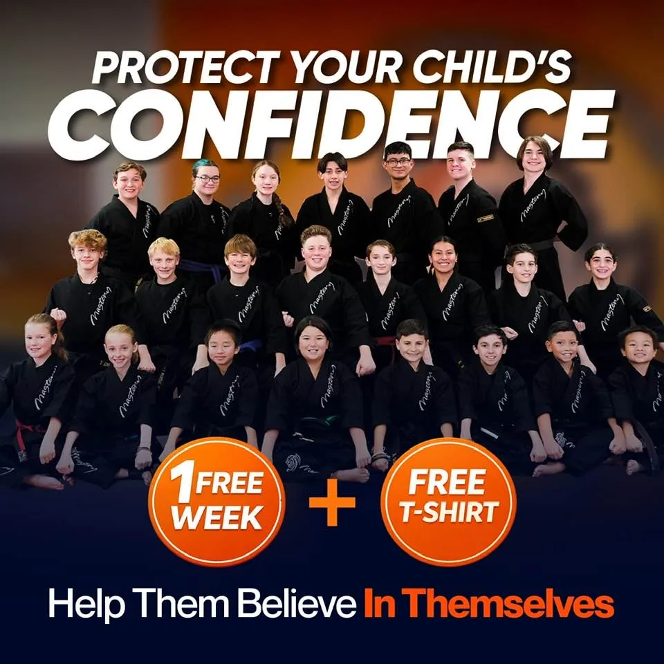 Confident child at Mastery Martial Arts Troy MI receiving instructor praise