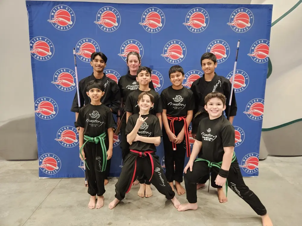Black Belt Story – Avi Braun 1 Avi Braun demonstrating a confident punch stance in martial arts gi at Mastery Martial Arts Troy Michigan
