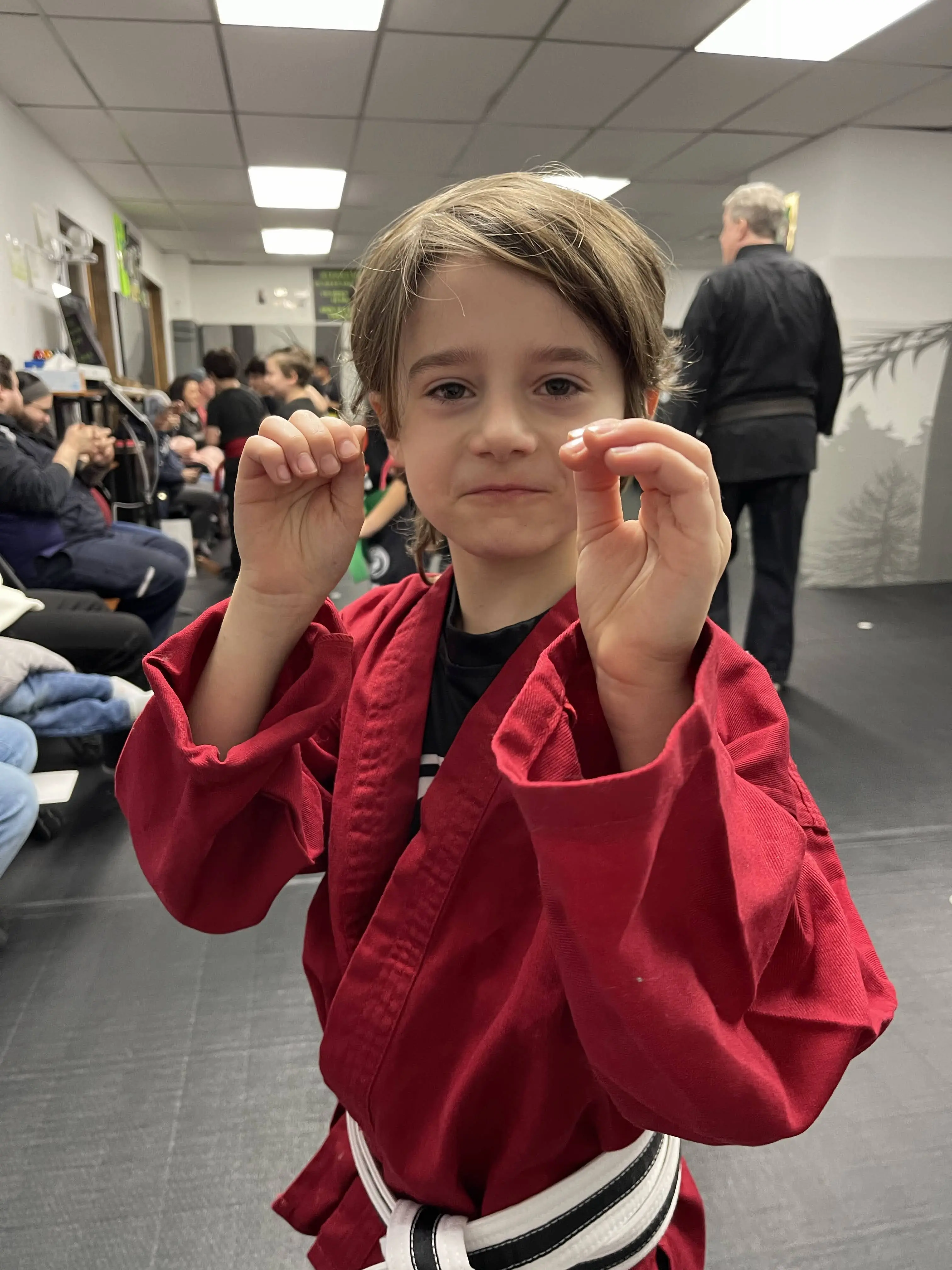 Black Belt Story – Avi Braun 7 Avi Braun with team members in martial arts uniforms at Mastery Martial Arts Troy Michigan