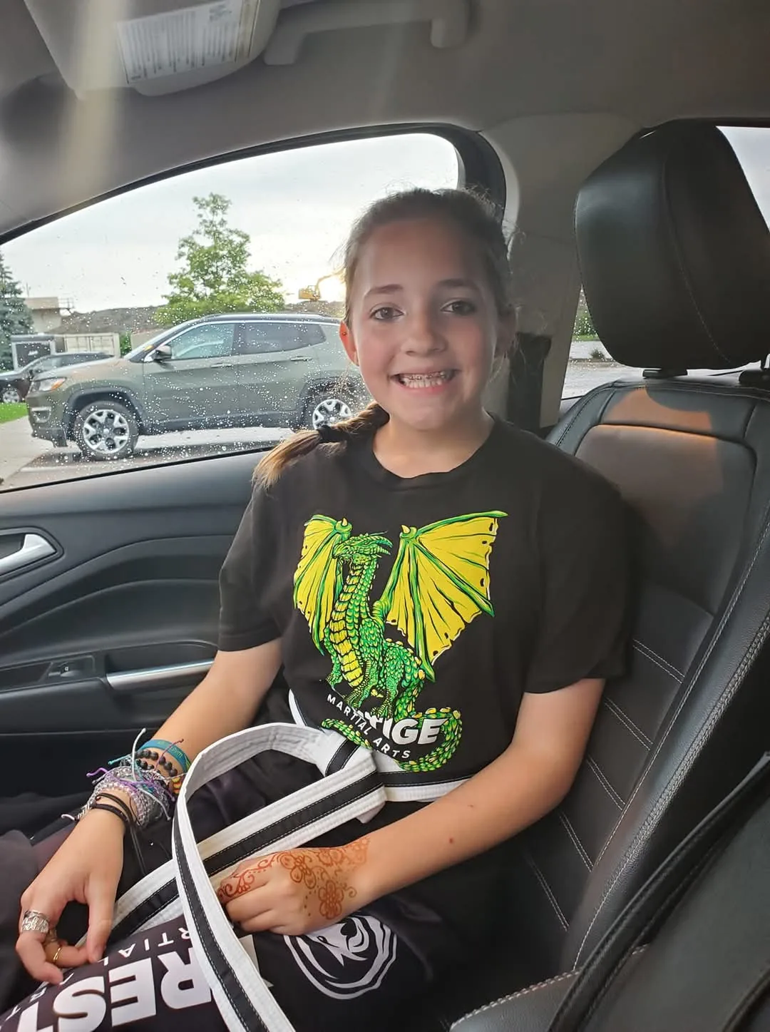 Kyleigh McCaw proudly holding her martial arts belt, showing confidence and pride in her achievements at Mastery Martial Arts