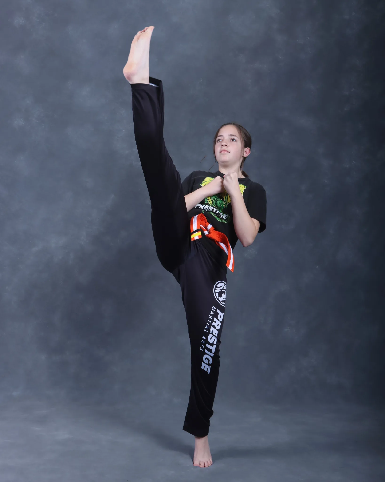 Kyleigh McCaw performing a powerful tornado kick during black belt training at Mastery Martial Arts Troy Michigan