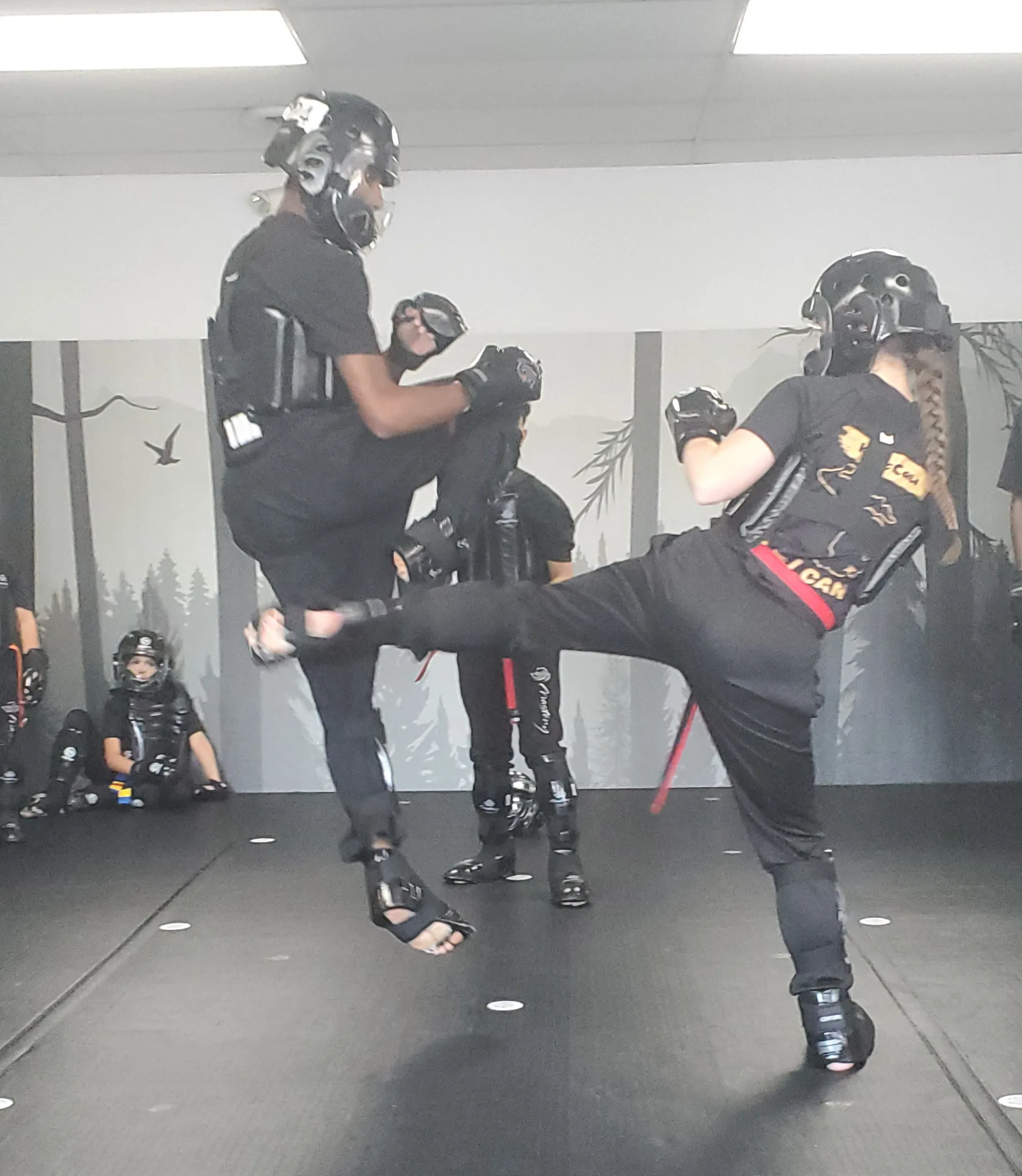 Kyleigh McCaw training with the Mastery Martial Arts demo team, performing advanced kicks and demonstrating martial arts excellence