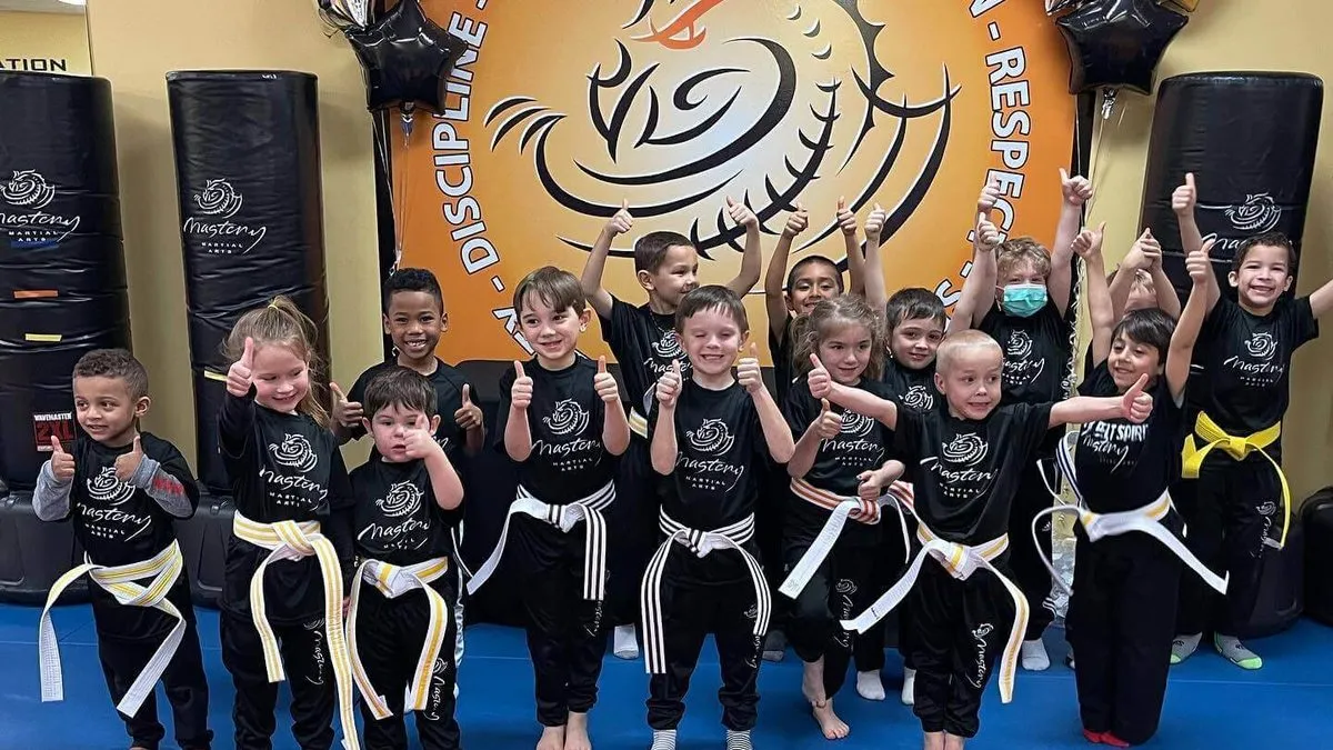 Best Children's Martial Arts School in Troy MI 2026 2 Kids giving a thumbs up in class at Mastery Martial Arts, named best children's martial arts school in Troy MI for 2026